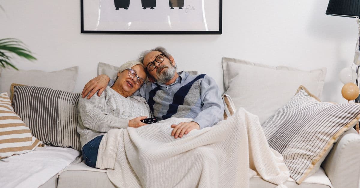 An older couple relaxing in their retirement village home
