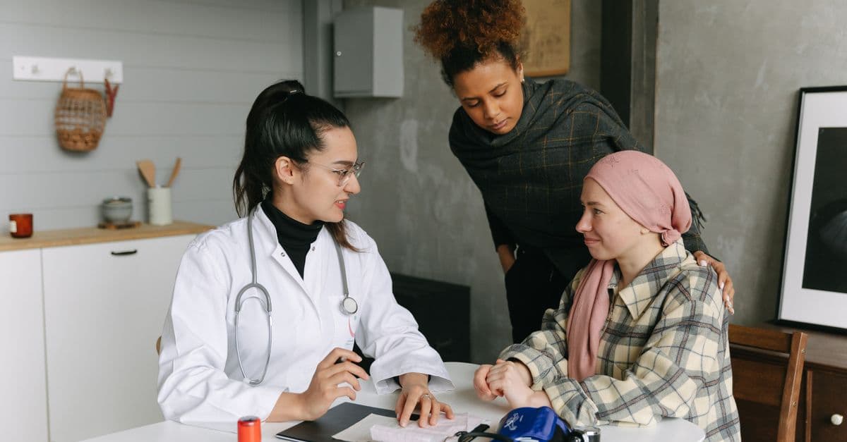 A patient discussing their care wishes with a doctor and a family member
