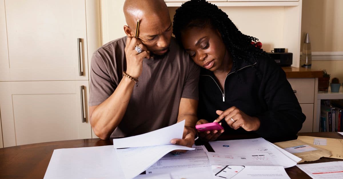 An older couple going through paperwork and costs together at home