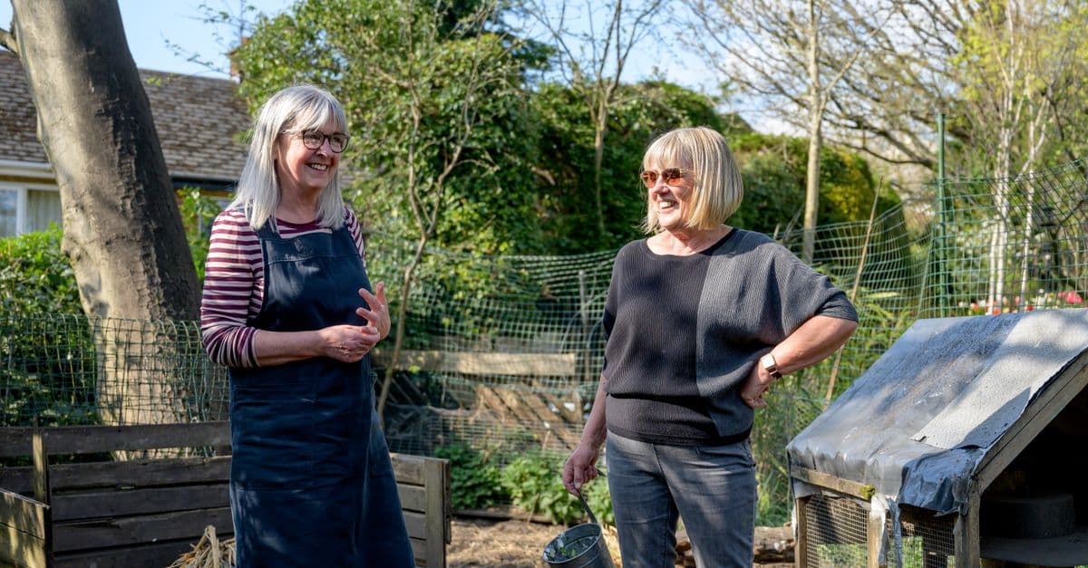 Older residents chatting outdoors in a retirement village garden