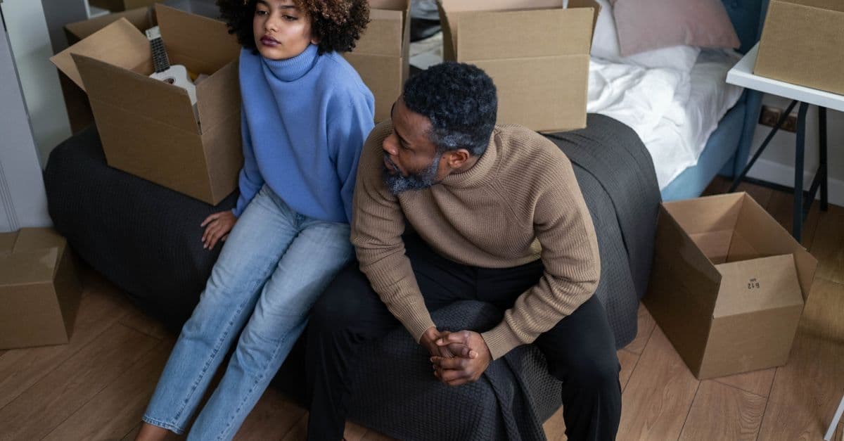 A couple among moving boxes as they prepare to move home
