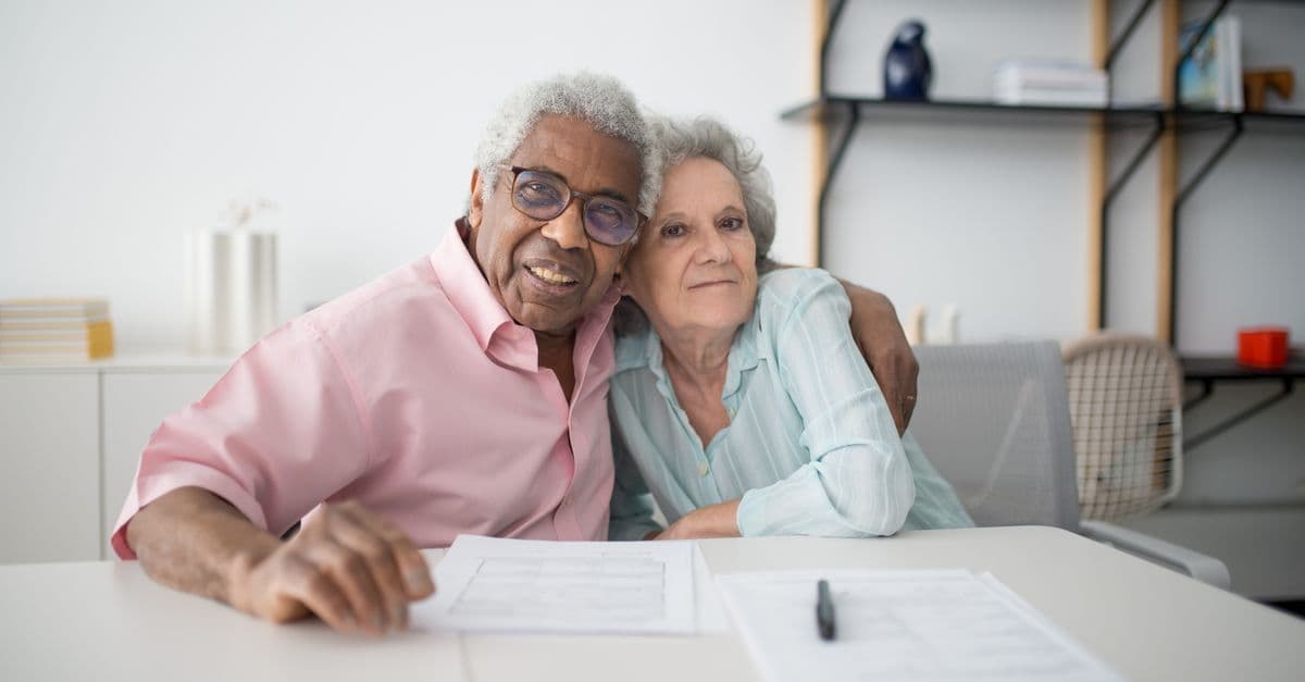 An older couple reviewing important documents together at home