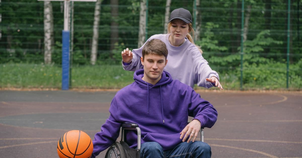 A person with disability enjoying sport with a support worker