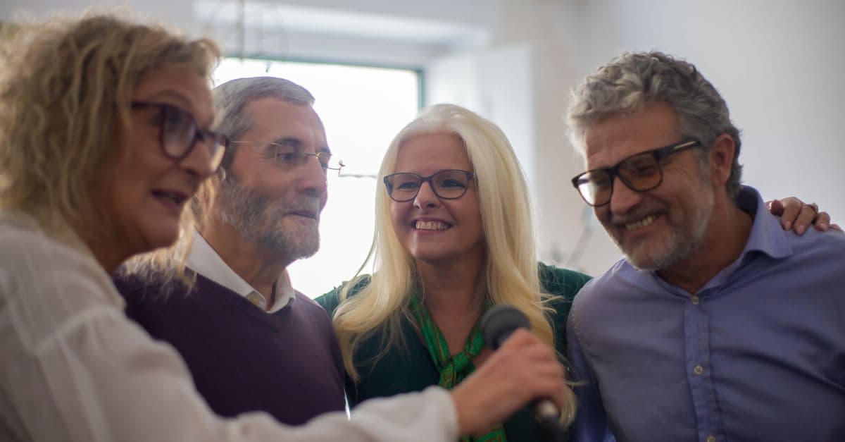 Older adults laughing together at a community group activity