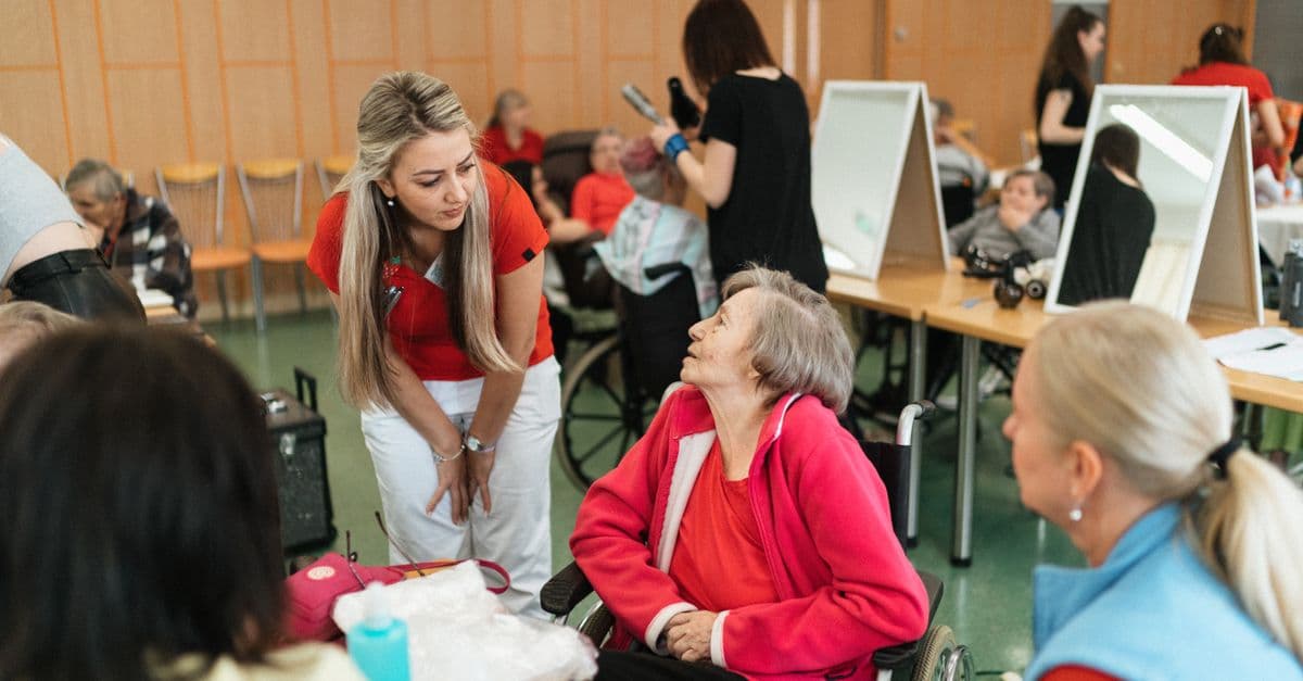 A care worker chatting warmly with a resident in an aged care home