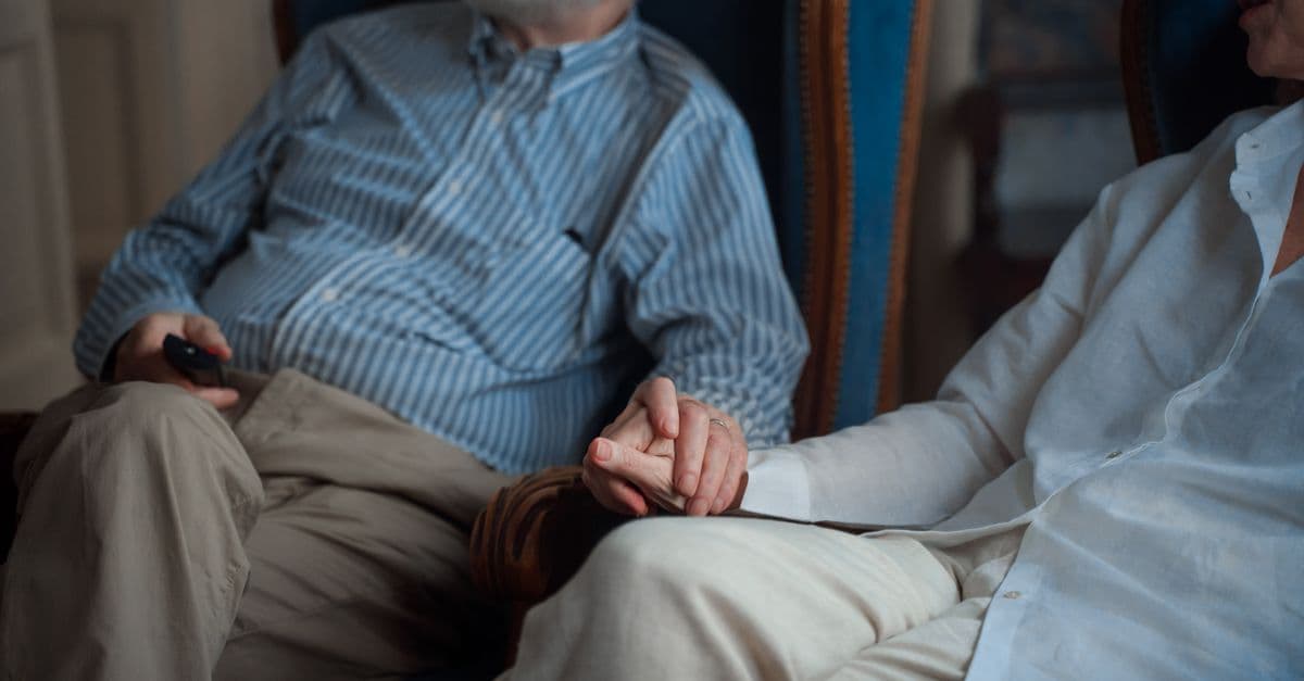 A carer offering comfort and support to an older person