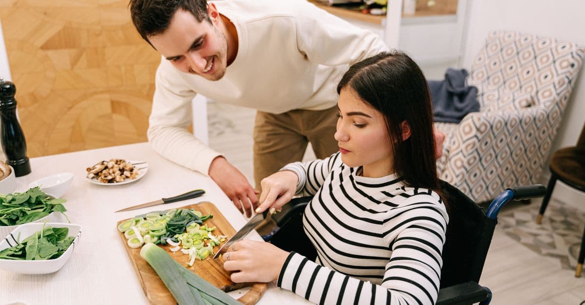 A support worker helping someone with a daily task at home