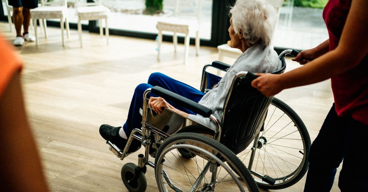 A home care worker assisting an older person