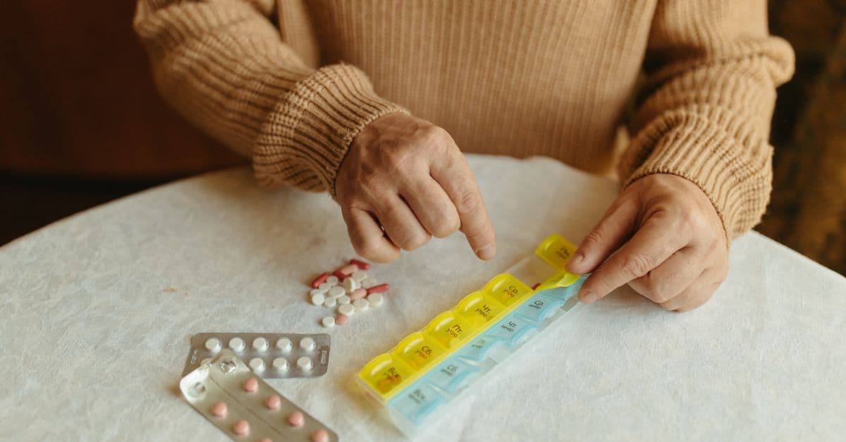 An older person reviewing their medications with a pharmacist