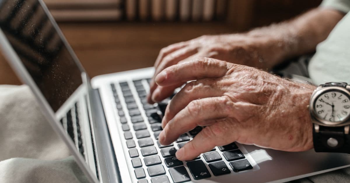 An older person using a computer to access aged care services