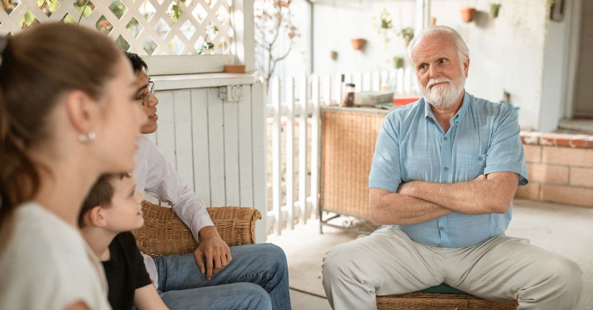 An adult child having a conversation with their older parent